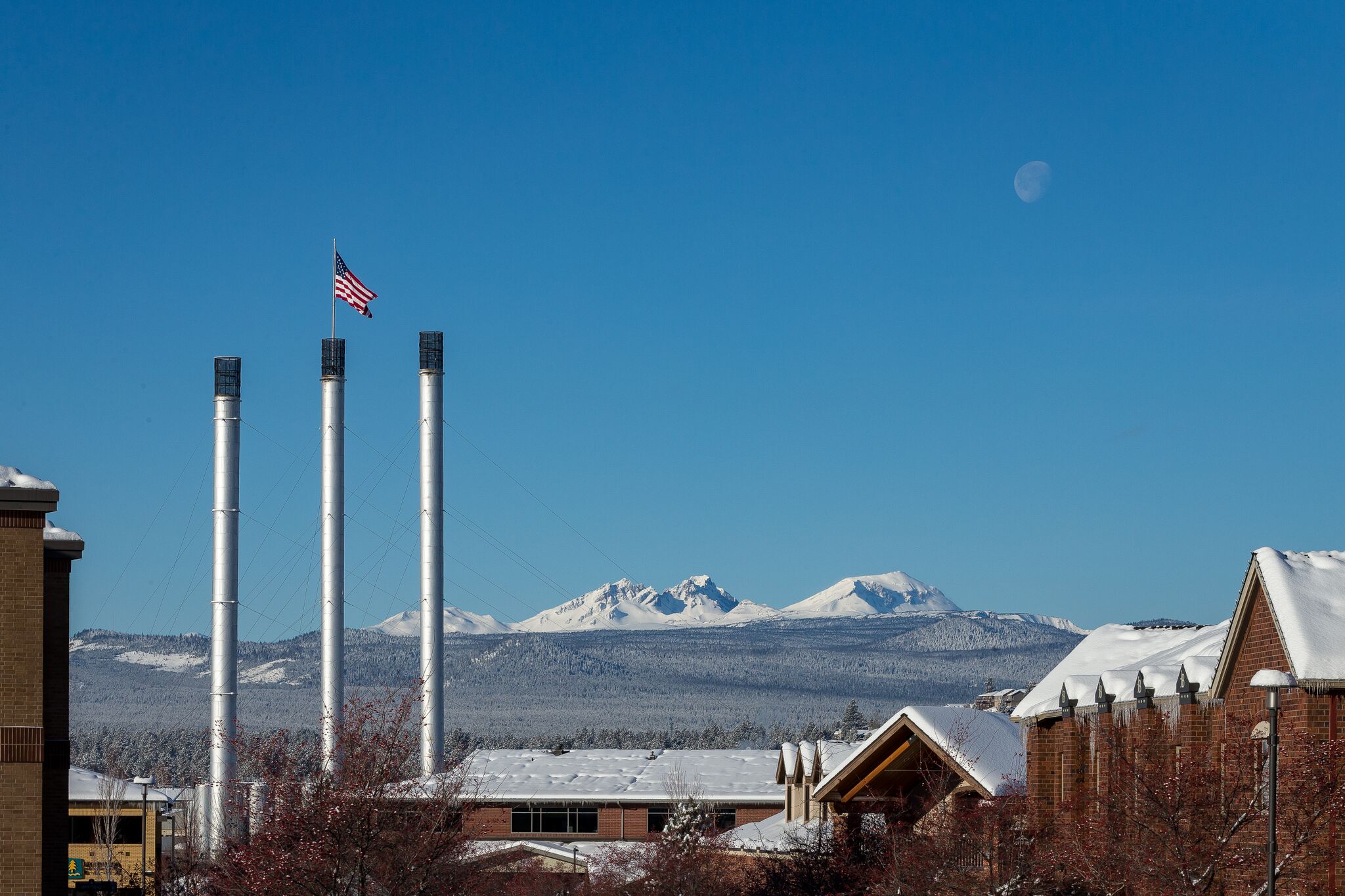 Bend Old Mill District with snow-covered Cascade mountains